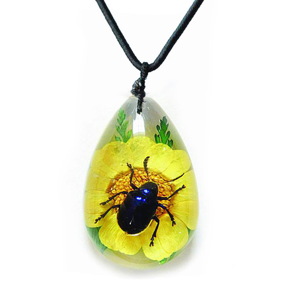 blue beetle on preserved flower necklace